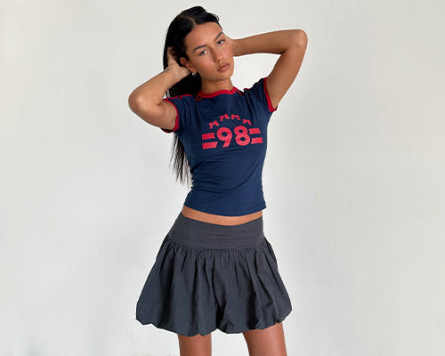 Afbeelding van Salda Tee in Navy met Adrenaline Red Binding en '98' Emb en Kiyowo Puffball Mini Skirt in Charcoal Grey